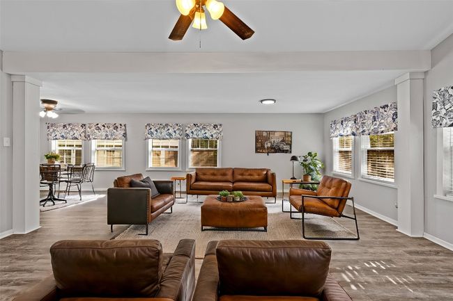 * Virtually Staged* Living area featuring baseboards, wood finished floors, a wealth of natural light, and ceiling fan | Image 10