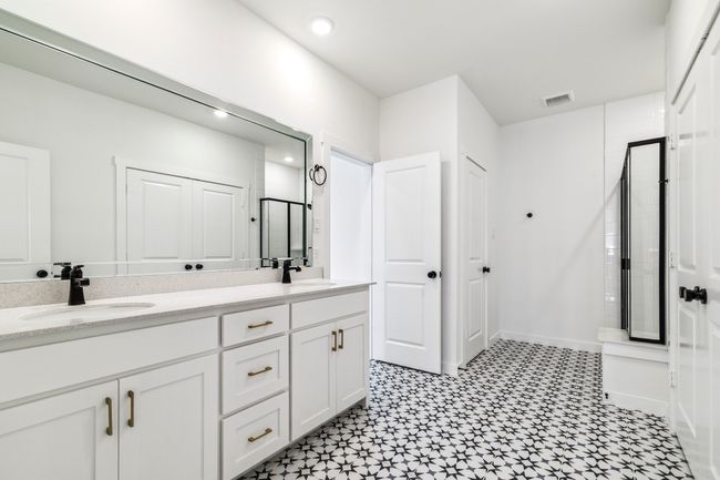 Full bathroom with tile patterned floors, double vanity, a shower, and recessed lighting | Image 20