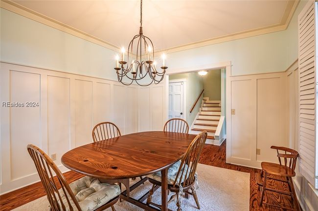 Dining room with an inviting chandelier and dark hardwood / wood-style floors | Image 16