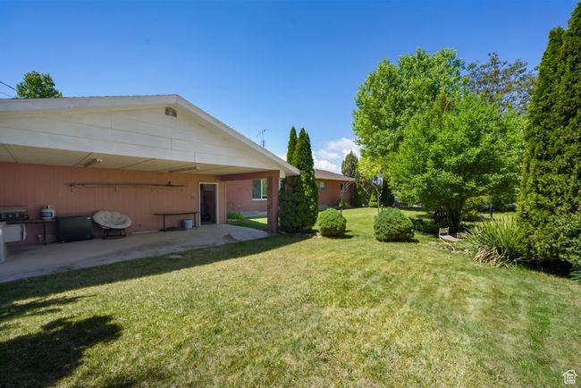 View of green lawn with a patio | Image 21