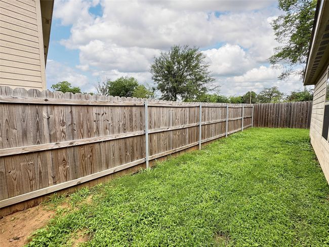 View of fenced backyard | Image 17