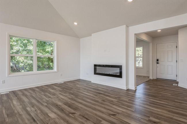 (*Photo of actual home) The spacious Great Room has a cozy electric fireplace and lots of natural sunlight | Image 6