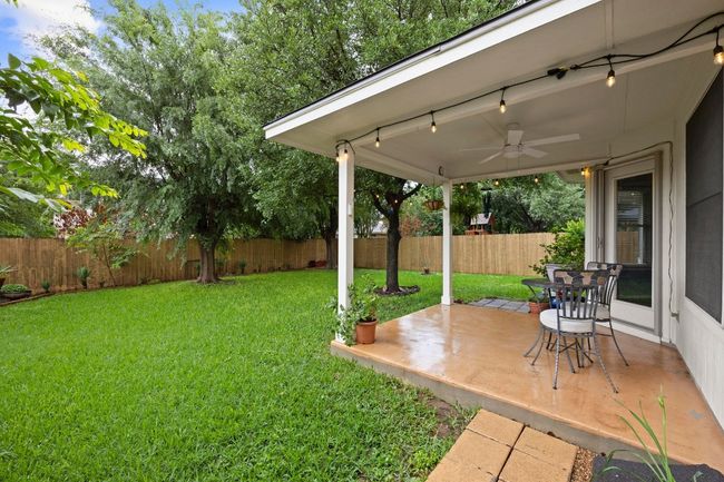 View of yard with a inviting covered patio with ceiling fan | Image 22