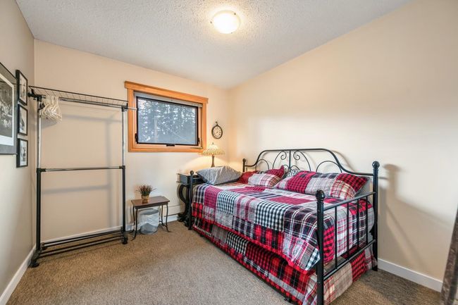 Carpeted bedroom featuring baseboards and a textured ceiling | Image 22