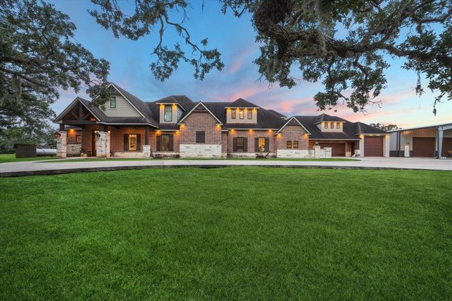 This custom-designed brick and stone main home features 5 spacious bedrooms, 4 full bathrooms, and 1 half bathroom. The attached in-law suite offers a second primary bedroom, a full primary bathroom, and a half bathroom, providing privacy and comfort for extended family or guests. Thoughtfully designed, this home blends elegance with functionality to accommodate multigenerational living. | Image 48