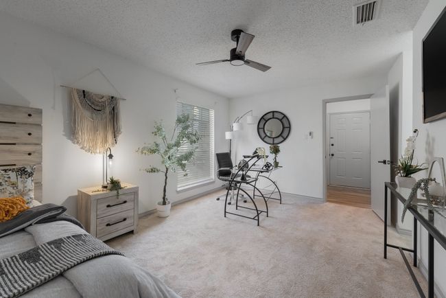 Carpeted bedroom featuring baseboards, a ceiling fan, a textured ceiling, and visible vents | Image 39