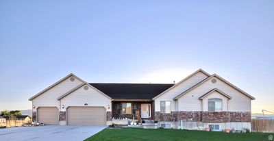 Ranch-style house with PHOTOSHOP lawn to show what it could look like, and a garage. | Image 1