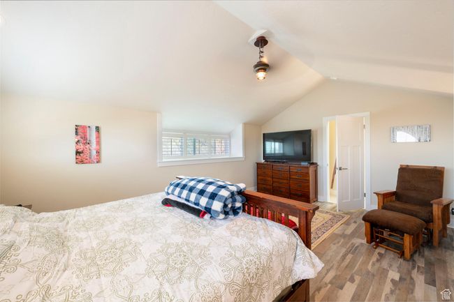 Bedroom featuring vaulted ceiling and wood finished floors | Image 27