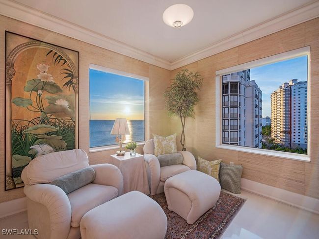 Living area featuring a view of city and crown molding | Image 10