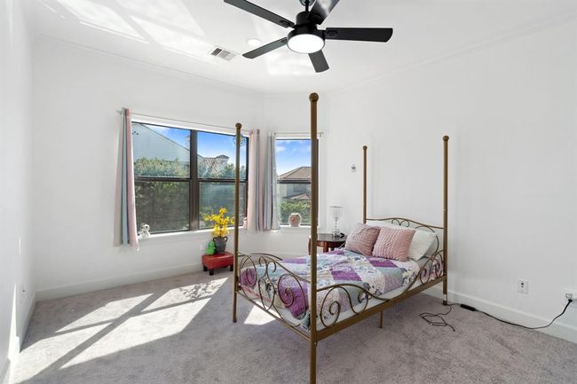Another view of the secondary bedroom, showcasing oversized windows that fill the room with natural light, creating a cozy and welcoming environment. | Image 41