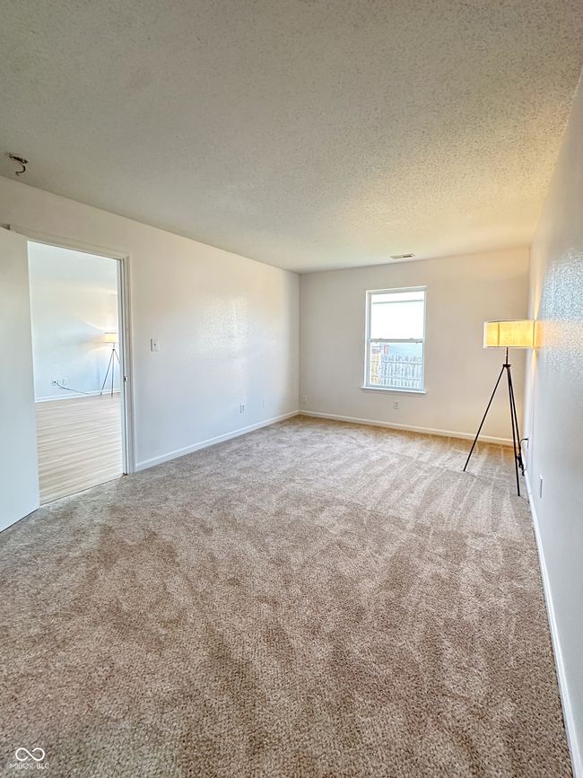 carpeted spare room with visible vents, baseboards, and a textured ceiling | Image 24