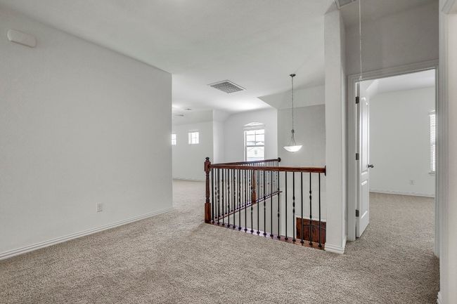 Hall with carpet, attic access, and an upstairs landing | Image 27