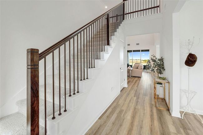 Entrance stairs with a high ceiling and wood finished floors | Image 9