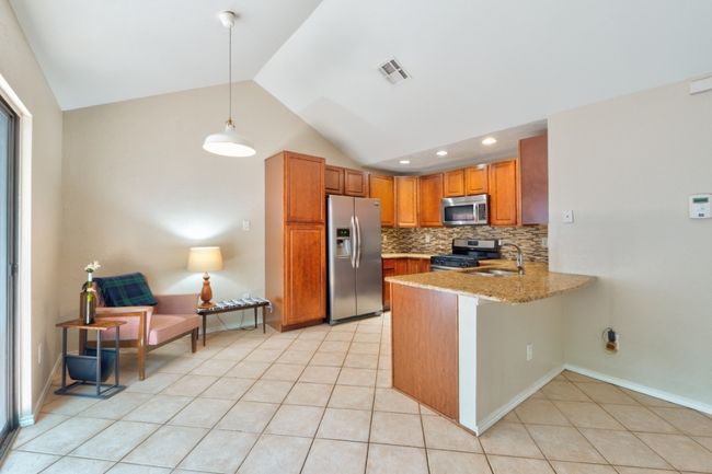 A chef's dream! You'll love this spacious kitchen featuring vaulted ceiling, recessed lighting, plenty of cabinets, and the perfect spot to enjoy easy meals. | Image 9