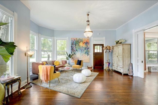 Living area with dark wood-type flooring and crown molding | Image 4