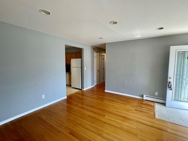 Spare room featuring recessed lighting, light wood-style flooring, a baseboard radiator, and baseboards | Image 16
