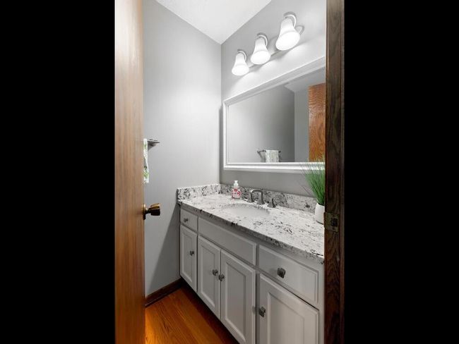 Half-bath on the main level with granite top vanity | Image 23