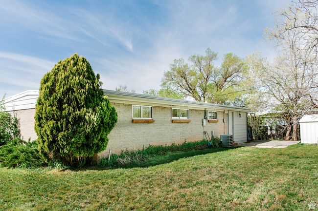 View of front of property featuring central AC unit and a front yard | Image 26
