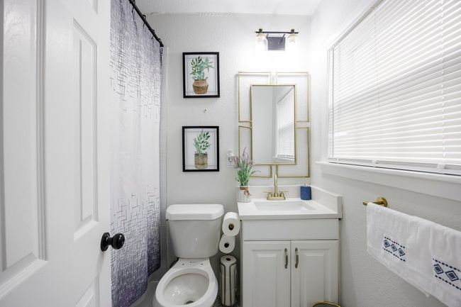 Bathroom featuring toilet and vanity | Image 16