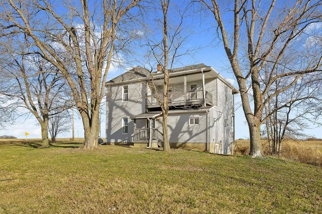 Rear view of property with a balcony, a yard, and a chimney | Image 28