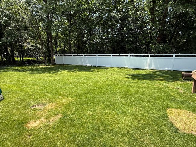 View of level backyard that is fully fenced.. | Image 25