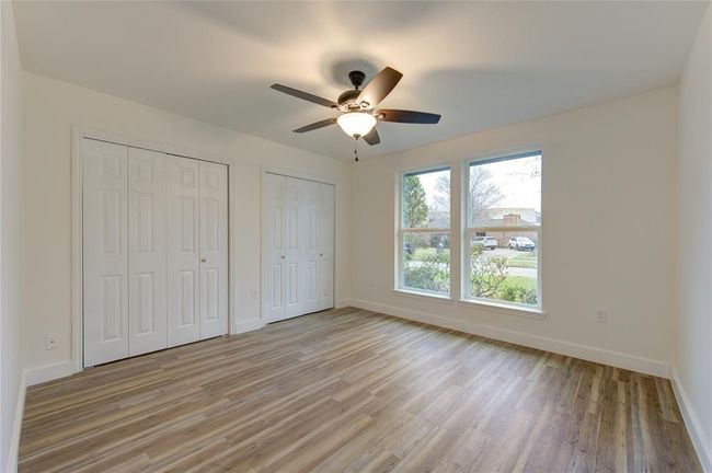 The three additional bedrooms are spacious and feature the same luxury vinyl flooring and natural light as the rest of the home. These rooms are freshly painted and offer versatility for use as bedrooms, home offices, or playrooms. Updated lighting and modern trim further enhance the updated look. | Image 22