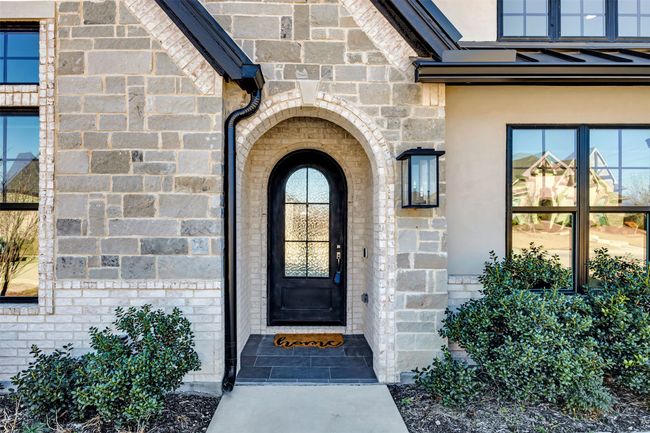Entrance to property featuring stone siding | Image 8