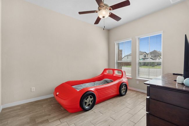 This main floor office is a perfect space for working from home, yet it easily doubles as a guest bedroom with close proximity to a full bathroom | Image 21