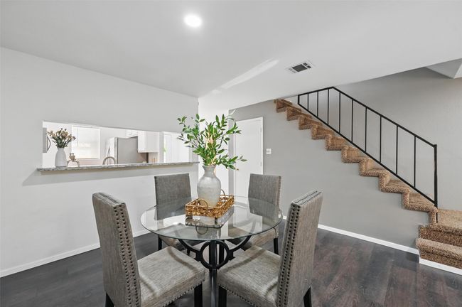 Dining area featuring visible vents, baseboards, stairway, and wood finished floors | Image 9