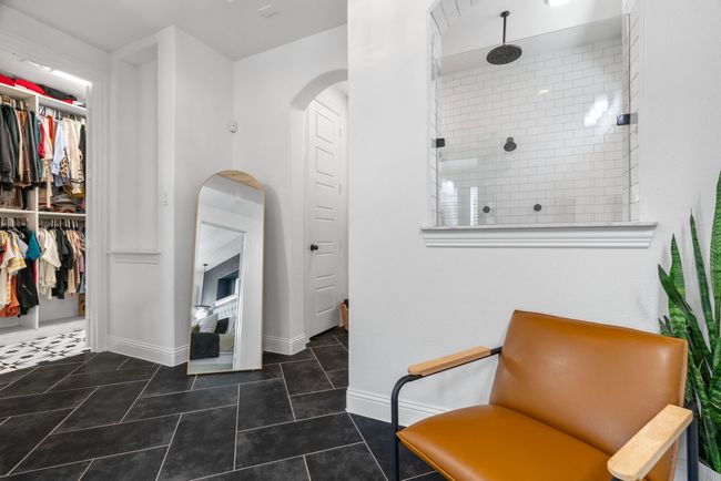 Living area featuring arched walkways, tile patterned floors, and baseboards | Image 18