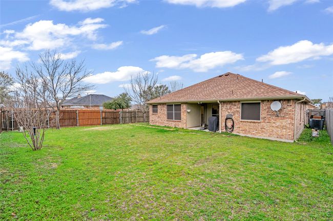 Back of house with a fenced backyard, a shingled roof, and brick siding | Image 28