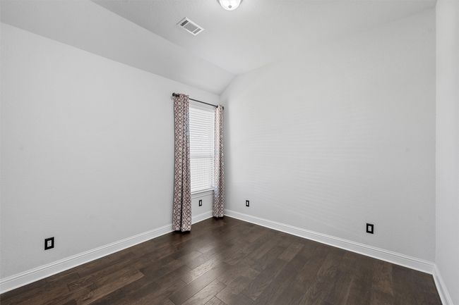 Unfurnished room with vaulted ceiling and dark wood-style flooring | Image 25