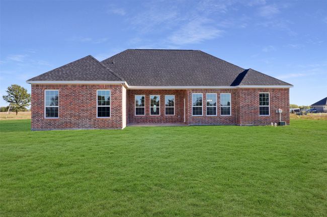 Rear view of property with roof with shingles, a lawn, and brick siding | Image 21