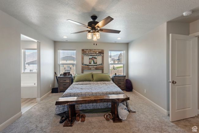 Bedroom with multiple windows, baseboards, and light colored carpet | Image 8