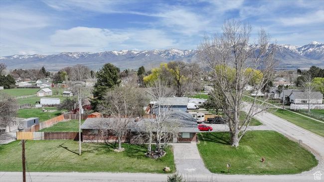 View of community with a yard, a mountain view, fence, and a residential view | Image 39