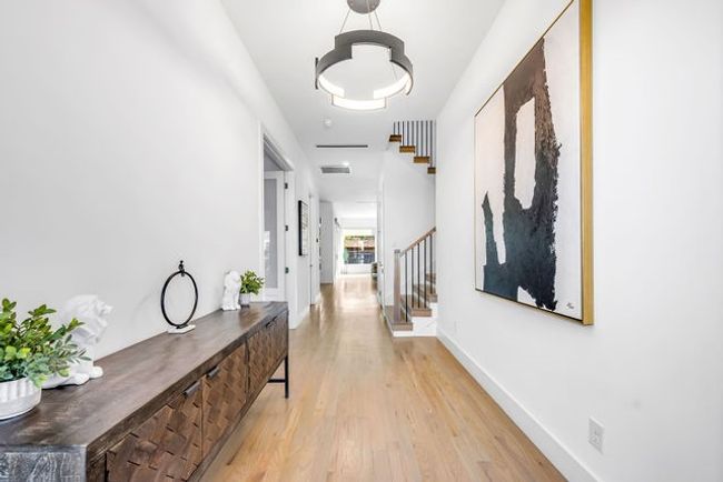 Hallway with light wood-type flooring | Image 7