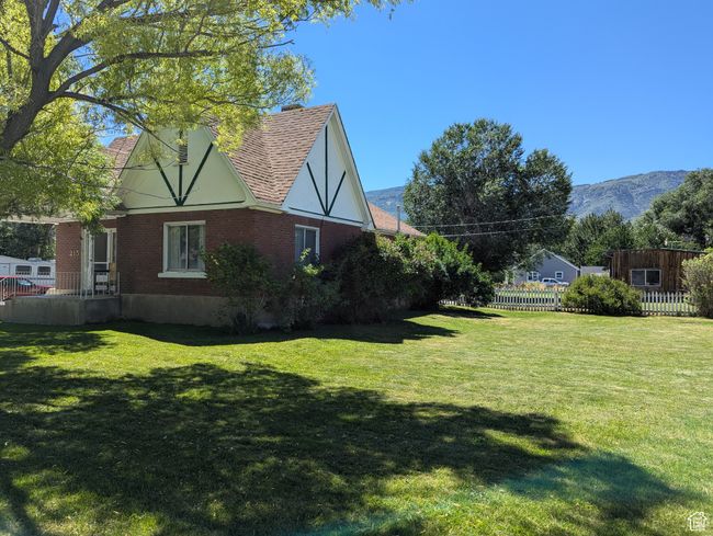 View of yard featuring a mountain view and fence | Image 42