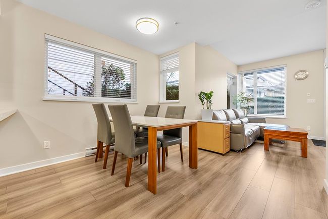 Dining room with light wood-type flooring and baseboards | Image 7