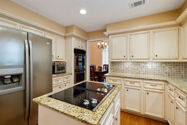 Channel your inner chef with this gourmet island cook top and a kitchen loaded with beautiful stainless steel appliances! | Image 15