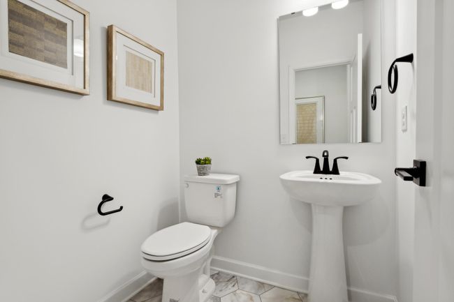 (Photo of a decorated model, actual homes finishes will vary) The main level powder bath. | Image 20