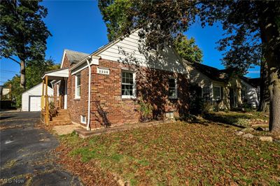 View of property exterior featuring an outdoor structure and a garage | Image 1