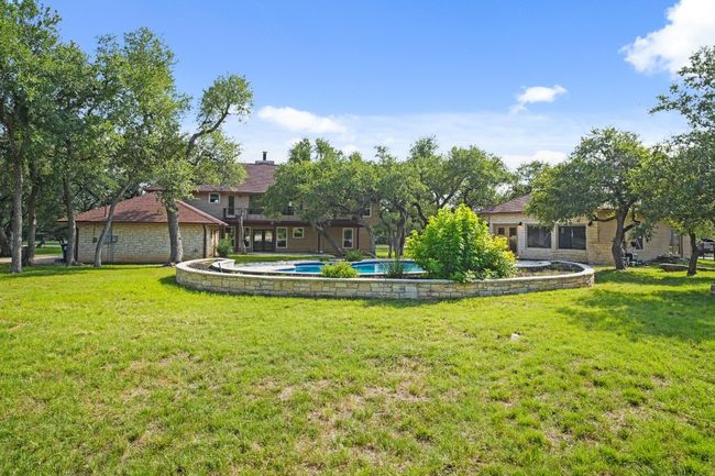 View of green lawn featuring an outdoor pool | Image 33