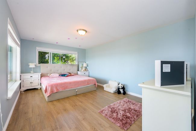 Bedroom with light wood-type flooring and baseboards | Image 24