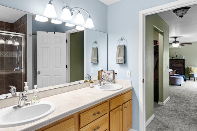 Ensuite bathroom with a stall shower, ceiling fan, and double vanity | Image 50