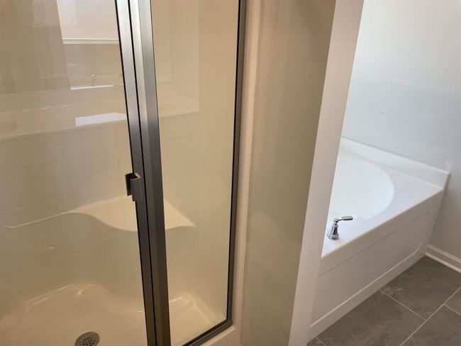 Garden tub and shower in this relaxing primary bathroom | Image 8