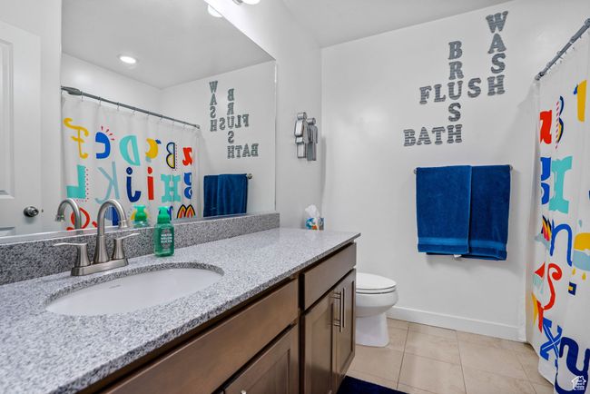 Bathroom featuring vanity, tile patterned floors, baseboards, and toilet | Image 22
