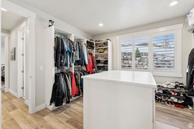 Spacious closet with light wood finished floors | Image 18