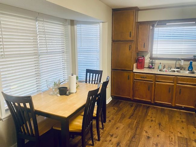 Dining area with dark wood-style flooring | Image 5