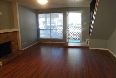 Unfurnished living room featuring ceiling fan and dark hardwood / wood-style floors | Image 2