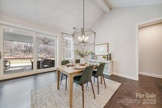 Open dining area with Catherdral Ceilings | Image 15